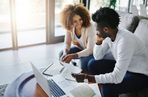 Shot of a young couple going through their paperwork together at home