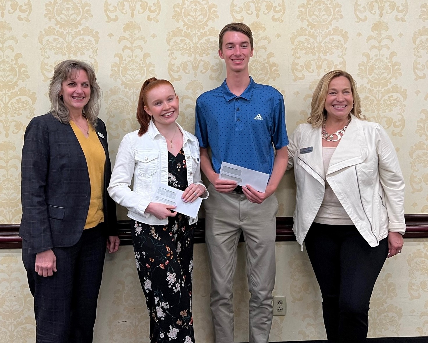 Group photo featuring two scholarship winners and CEOs.