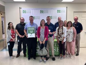 Dallastown Educators stand with White Rose staff in the Corporate Office Lobby.